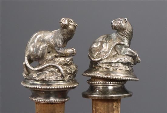 A pair of Victorian silver plated bottle stoppers modelled with recumbent panthers, 9cm